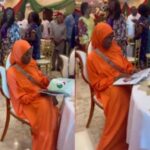 Moment Aisha Yesufu Remains Seated During New National Anthem at Event